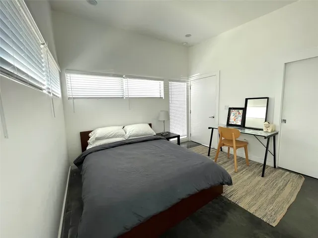 a bedroom with a bed and a table