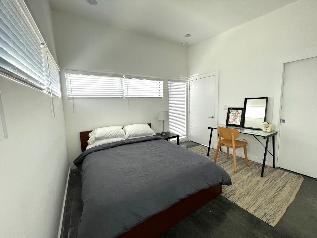 1159 Perry Road, Unit A Austin, TX 78721 - Photo 14 of 23 Bedroom featuring multiple windows