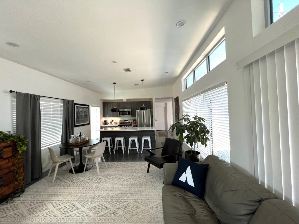 1159 Perry Road, Unit A Austin, TX 78721 - Photo 18 of 23 Living room featuring a towering ceiling