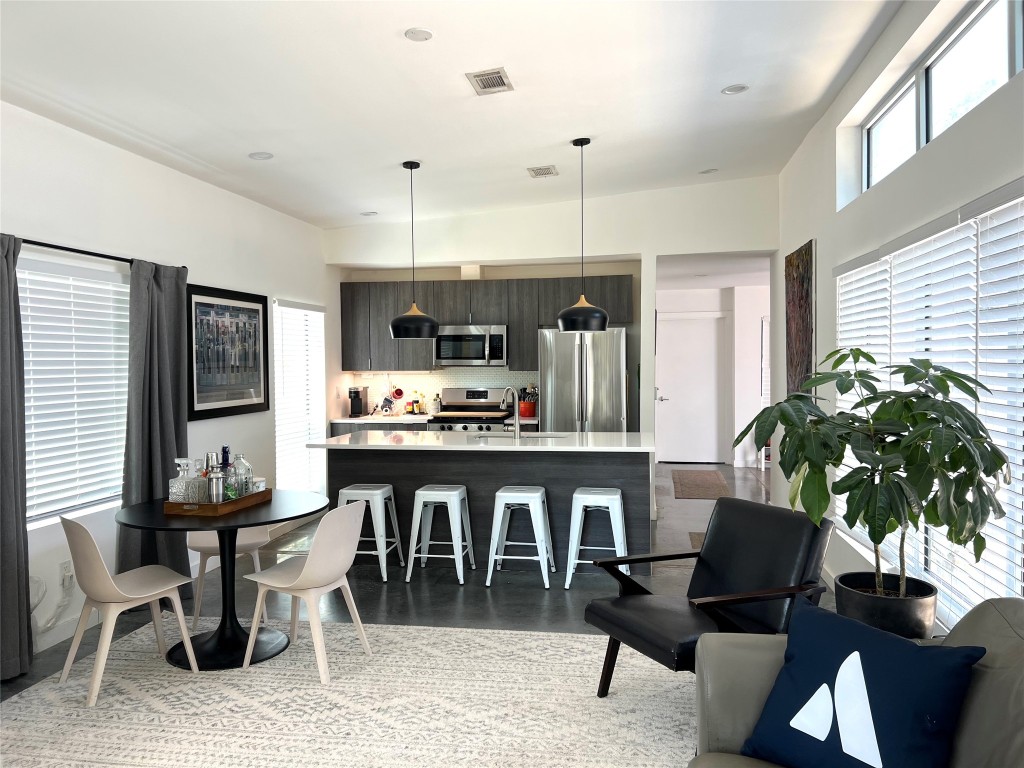 1159 Perry Road, Unit A Austin, TX 78721 - Photo 10 of 23 Dining area featuring a towering ceiling