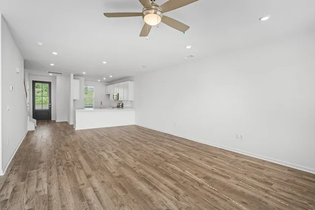 a view of kitchen and hall with wooden floor