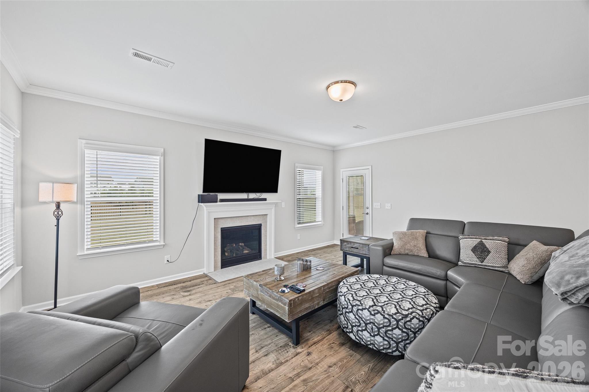 12000 Sam Snead Court Lancaster, SC 29720 - Photo 11 of 36 a living room with furniture a fireplace and a flat screen tv
