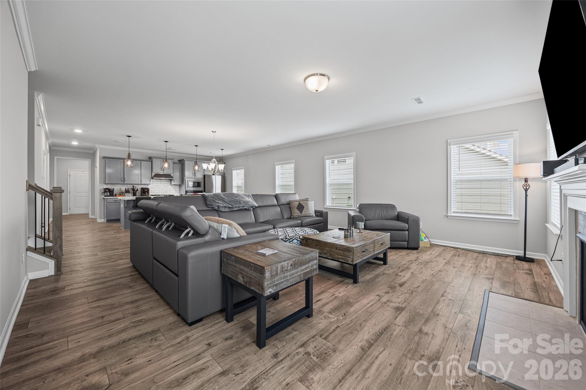12000 Sam Snead Court Lancaster, SC 29720 - Photo 12 of 36 a living room with couches and a flat screen tv with kitchen view