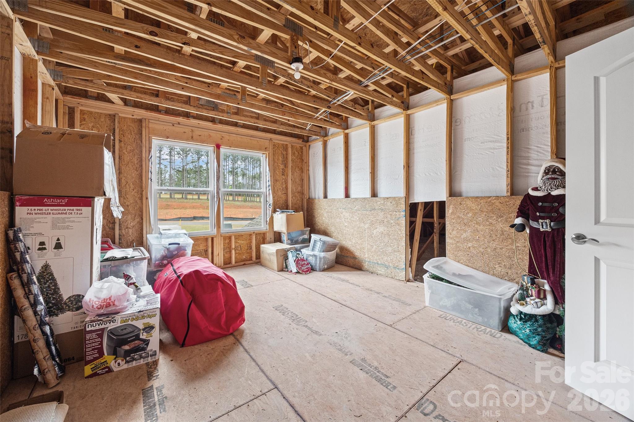 12000 Sam Snead Court Lancaster, SC 29720 - Photo 25 of 36 a spacious bedroom with a bed and a chandelier