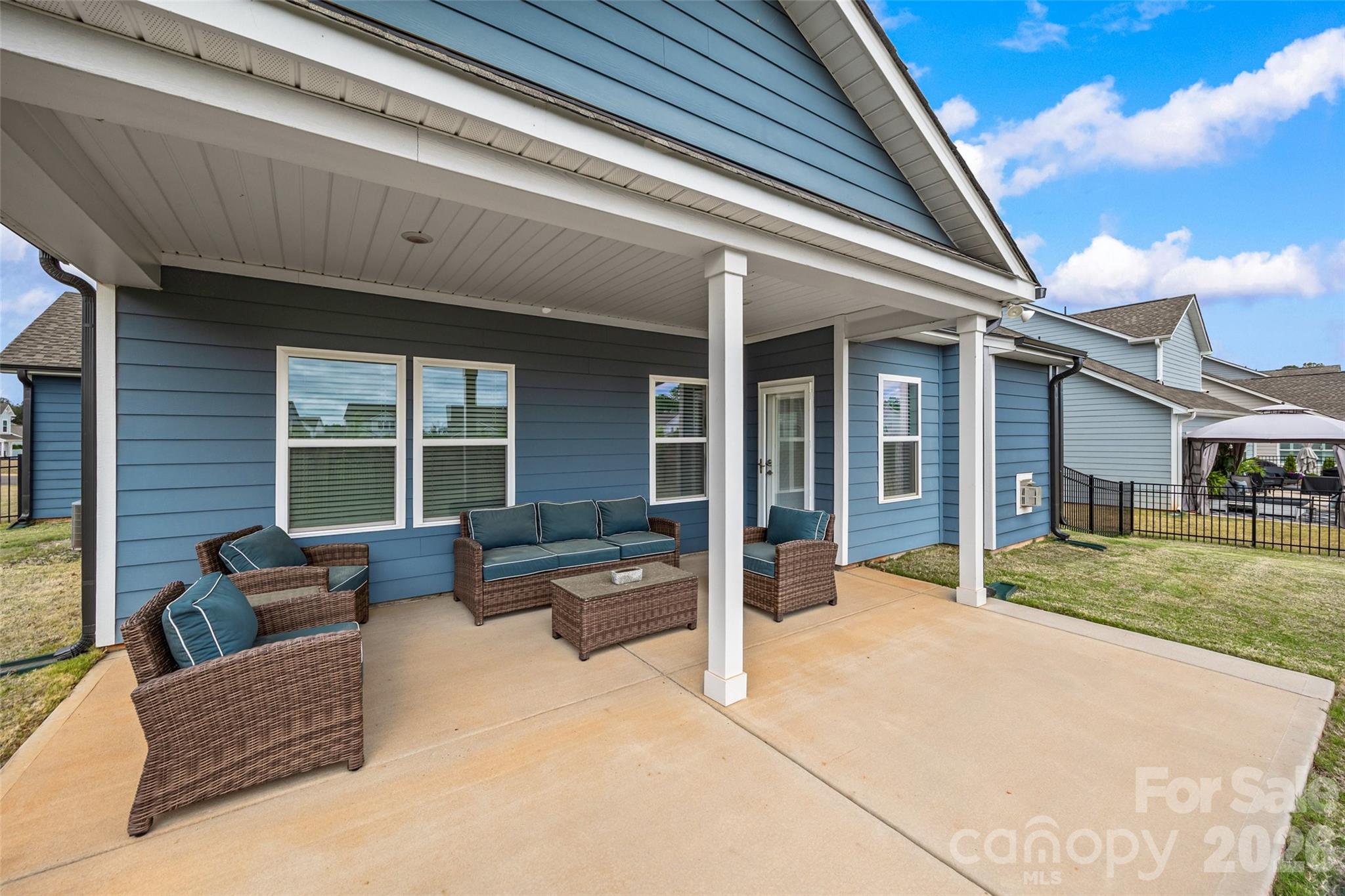 12000 Sam Snead Court Lancaster, SC 29720 - Photo 27 of 36 a view of a patio with couches and table and chairs and potted plants