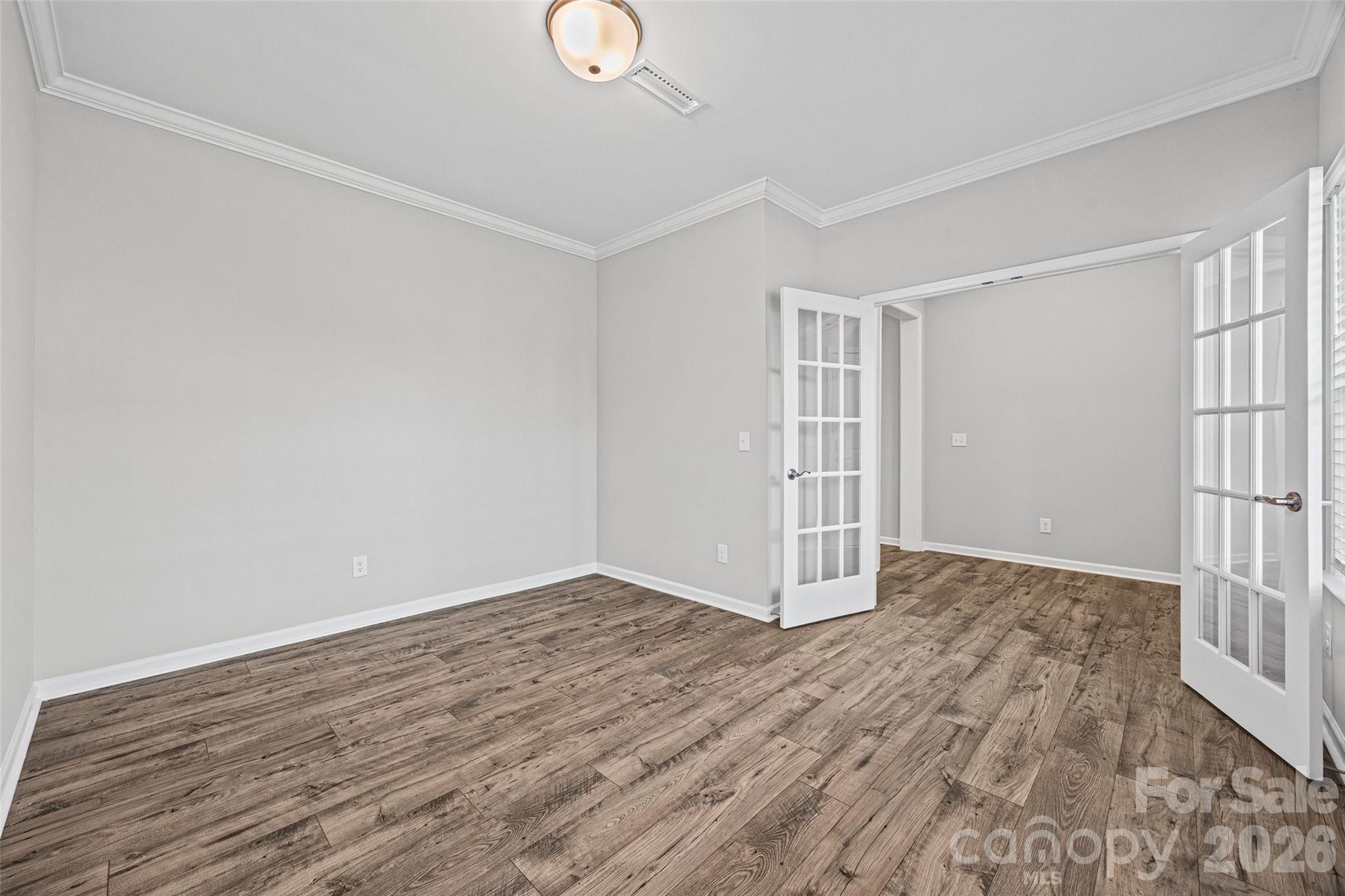 12000 Sam Snead Court Lancaster, SC 29720 - Photo 4 of 36 an empty room with wooden floor and windows