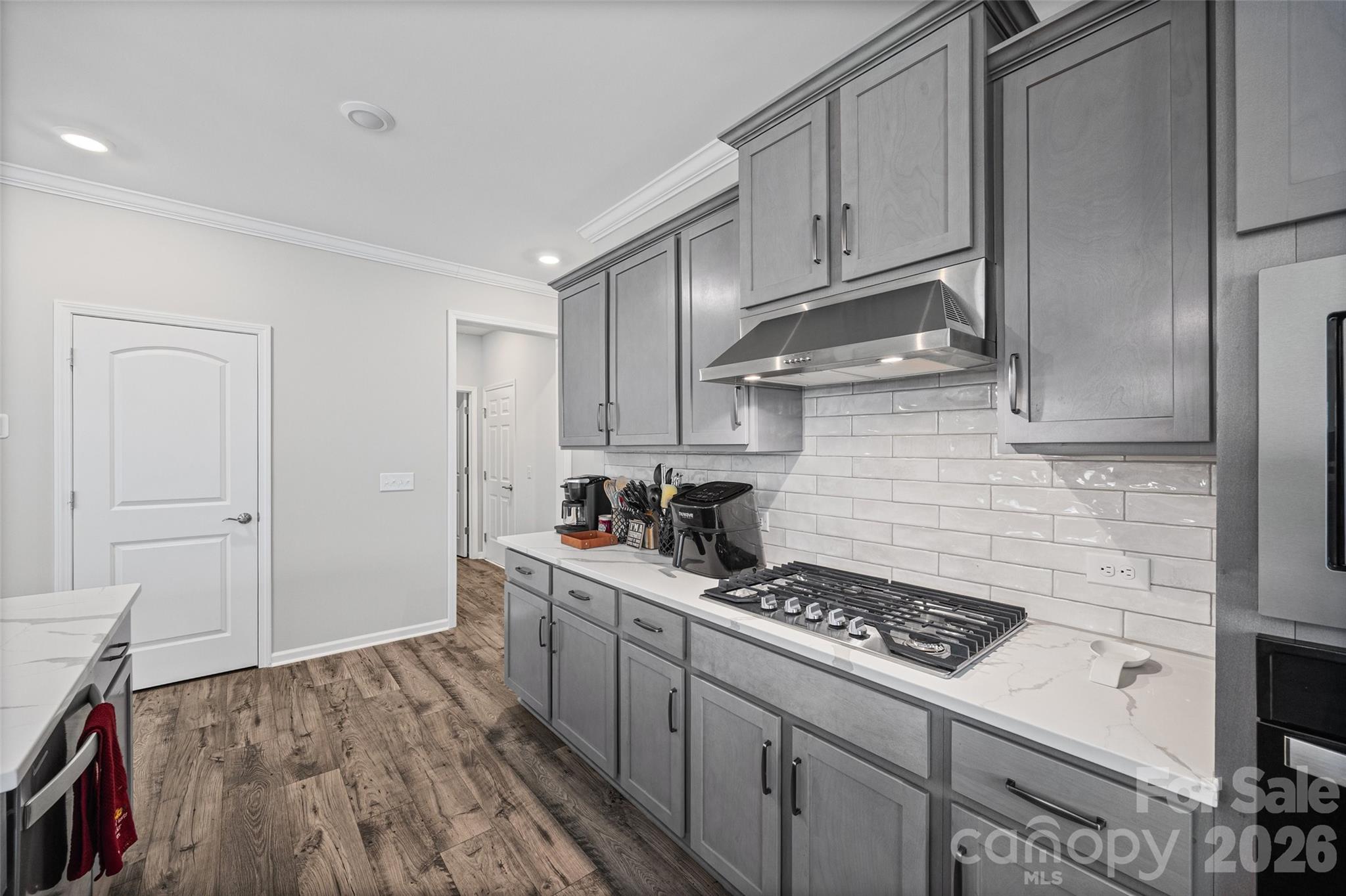 12000 Sam Snead Court Lancaster, SC 29720 - Photo 8 of 36 a kitchen with a stove and a wooden floor