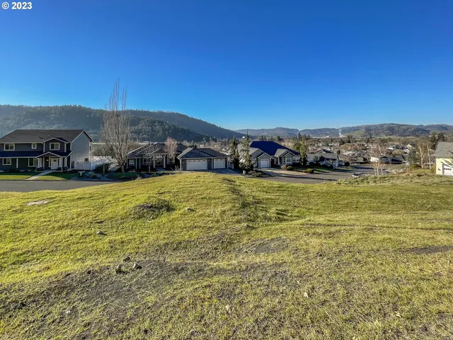 a view of a ocean with mountains in the background
