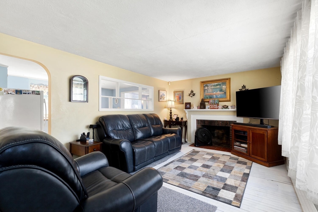 63 Baldwin Road Billerica, MA 01821 - Photo 14 of 38 a living room with furniture and a flat screen tv