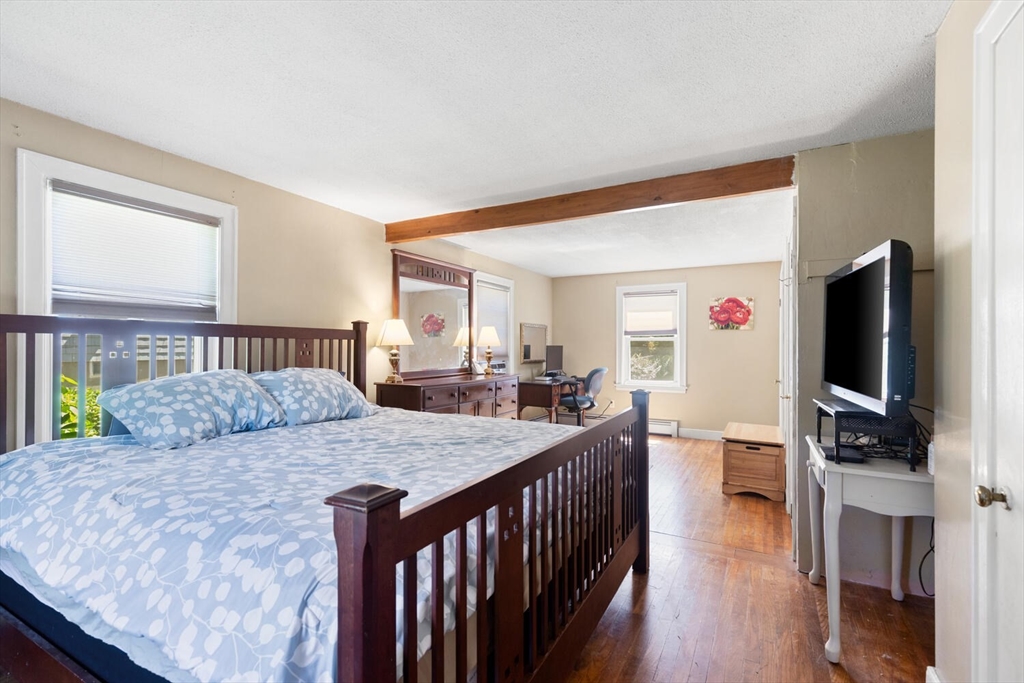 63 Baldwin Road Billerica, MA 01821 - Photo 18 of 38 a bedroom with a bed and a flat screen tv