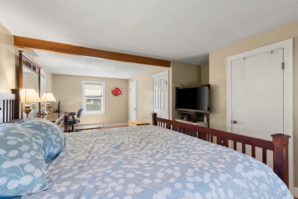 63 Baldwin Road Billerica, MA 01821 - Photo 19 of 38 a bedroom with a bed and a flat screen tv
