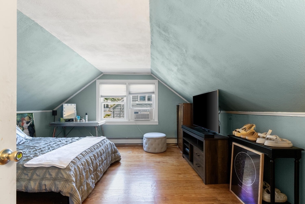 63 Baldwin Road Billerica, MA 01821 - Photo 21 of 38 a bedroom with a bed and a flat screen tv