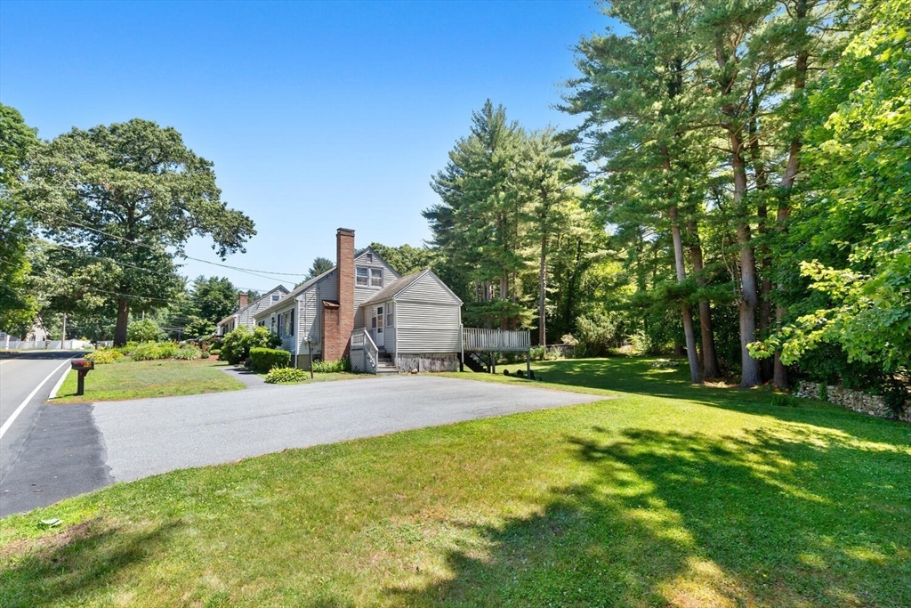 63 Baldwin Road Billerica, MA 01821 - Photo 3 of 38 a view of a yard with a house in the background