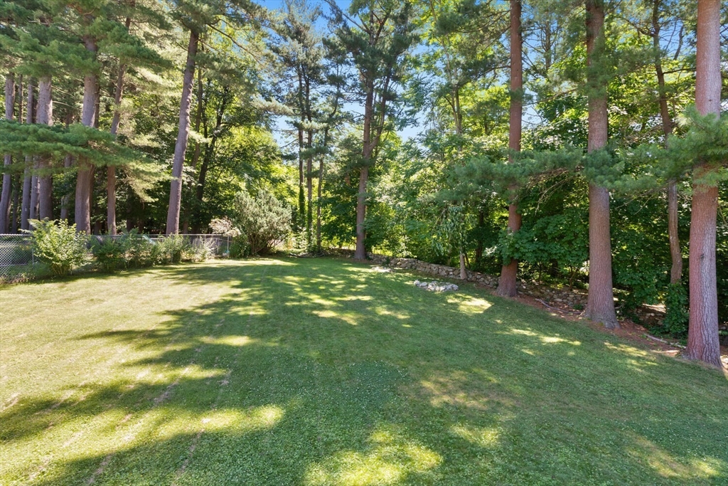 63 Baldwin Road Billerica, MA 01821 - Photo 31 of 38 a backyard of a house with lots of green space