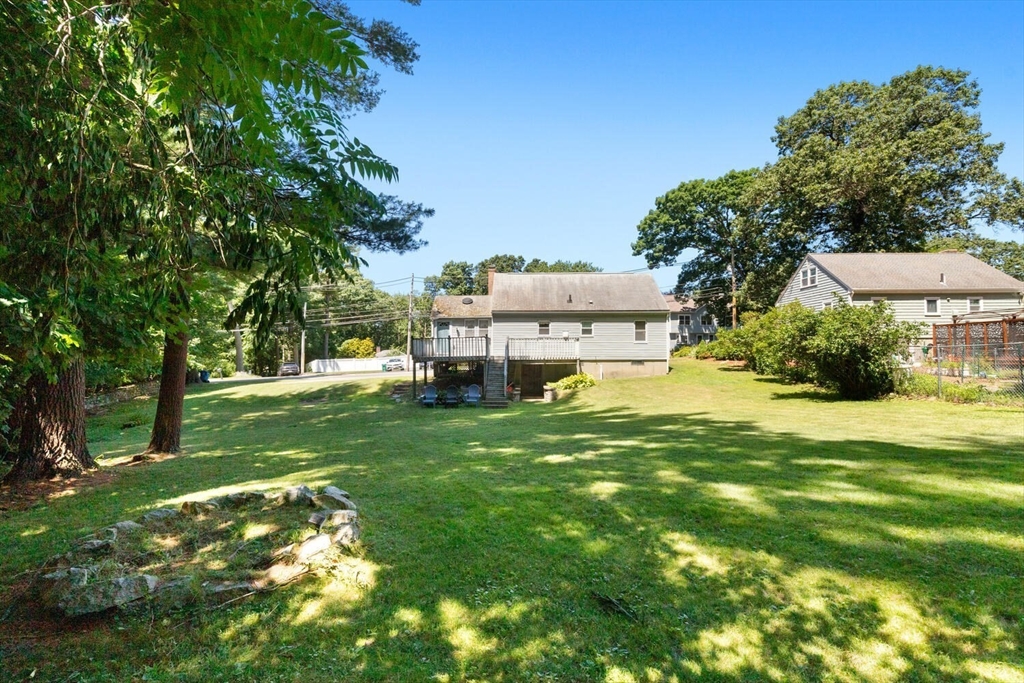63 Baldwin Road Billerica, MA 01821 - Photo 34 of 38 a view of a house with a big yard potted plants and large tree