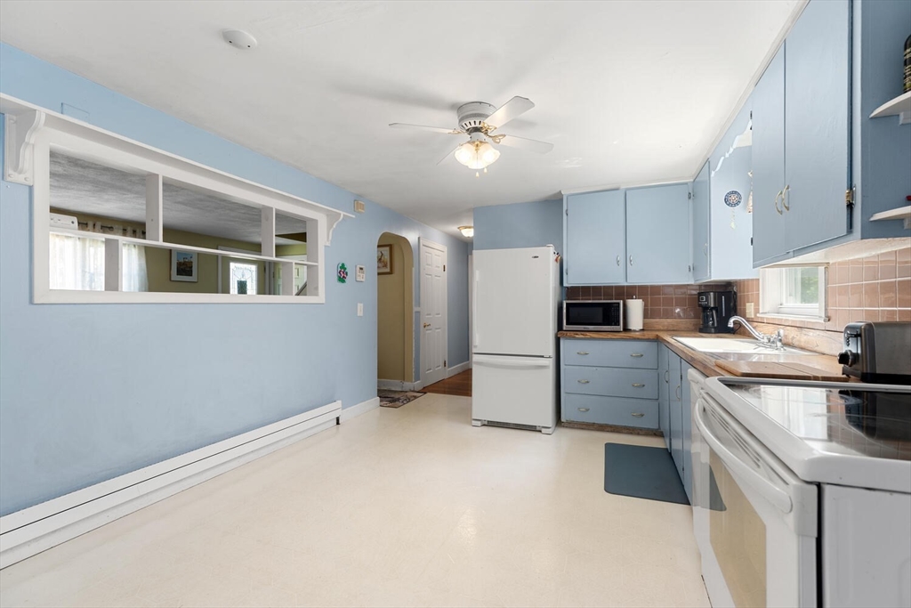 63 Baldwin Road Billerica, MA 01821 - Photo 4 of 38 a kitchen with refrigerator and cabinets
