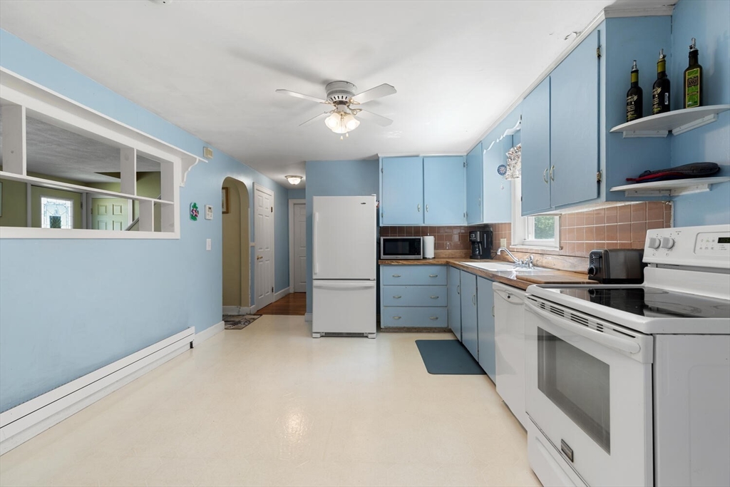 63 Baldwin Road Billerica, MA 01821 - Photo 5 of 38 a kitchen with stainless steel appliances a refrigerator sink and cabinets