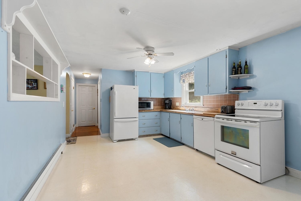 63 Baldwin Road Billerica, MA 01821 - Photo 6 of 38 a kitchen with a refrigerator sink and cabinets