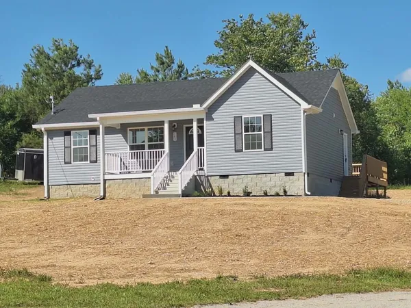 a house that has a tree in front of it