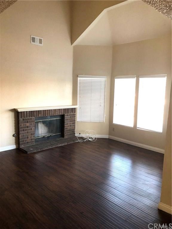 632 North Birch Avenue Rialto, CA 92376 - Photo 13 of 24 a view of empty room with wooden floor and fireplace