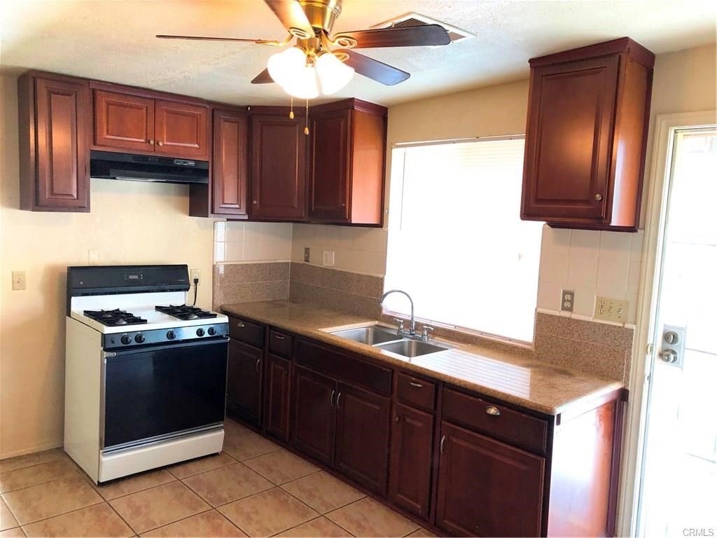 632 North Birch Avenue Rialto, CA 92376 - Photo 20 of 24 a kitchen with stainless steel appliances granite countertop a sink stove and refrigerator