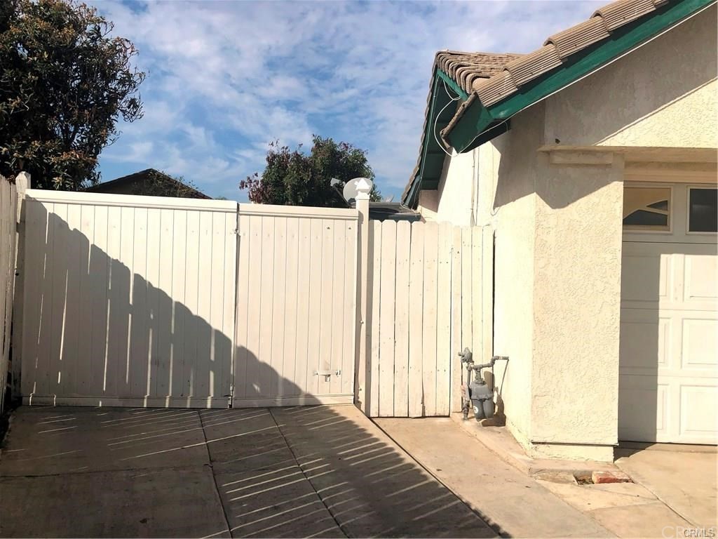 632 North Birch Avenue Rialto, CA 92376 - Photo 24 of 24 a street view with wooden fence and trees