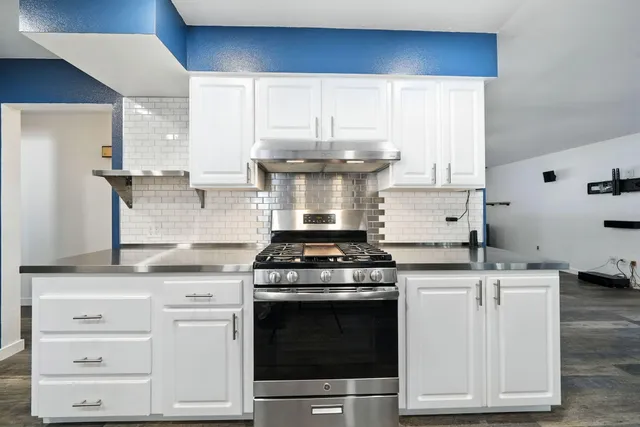 a kitchen with a stove and cabinets