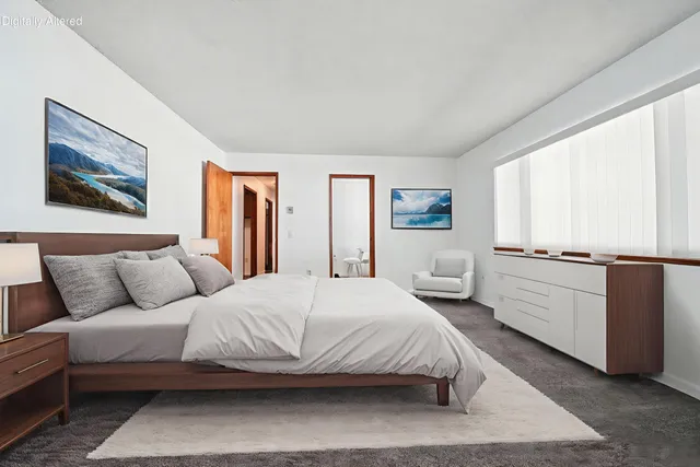 a bedroom with a large bed and a large window