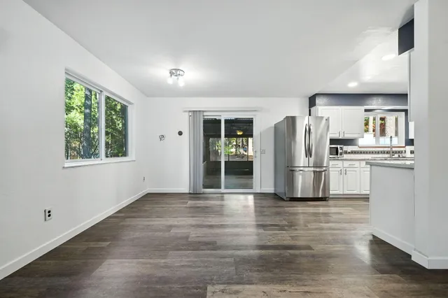 a kitchen with stainless steel appliances a refrigerator sink and cabinets
