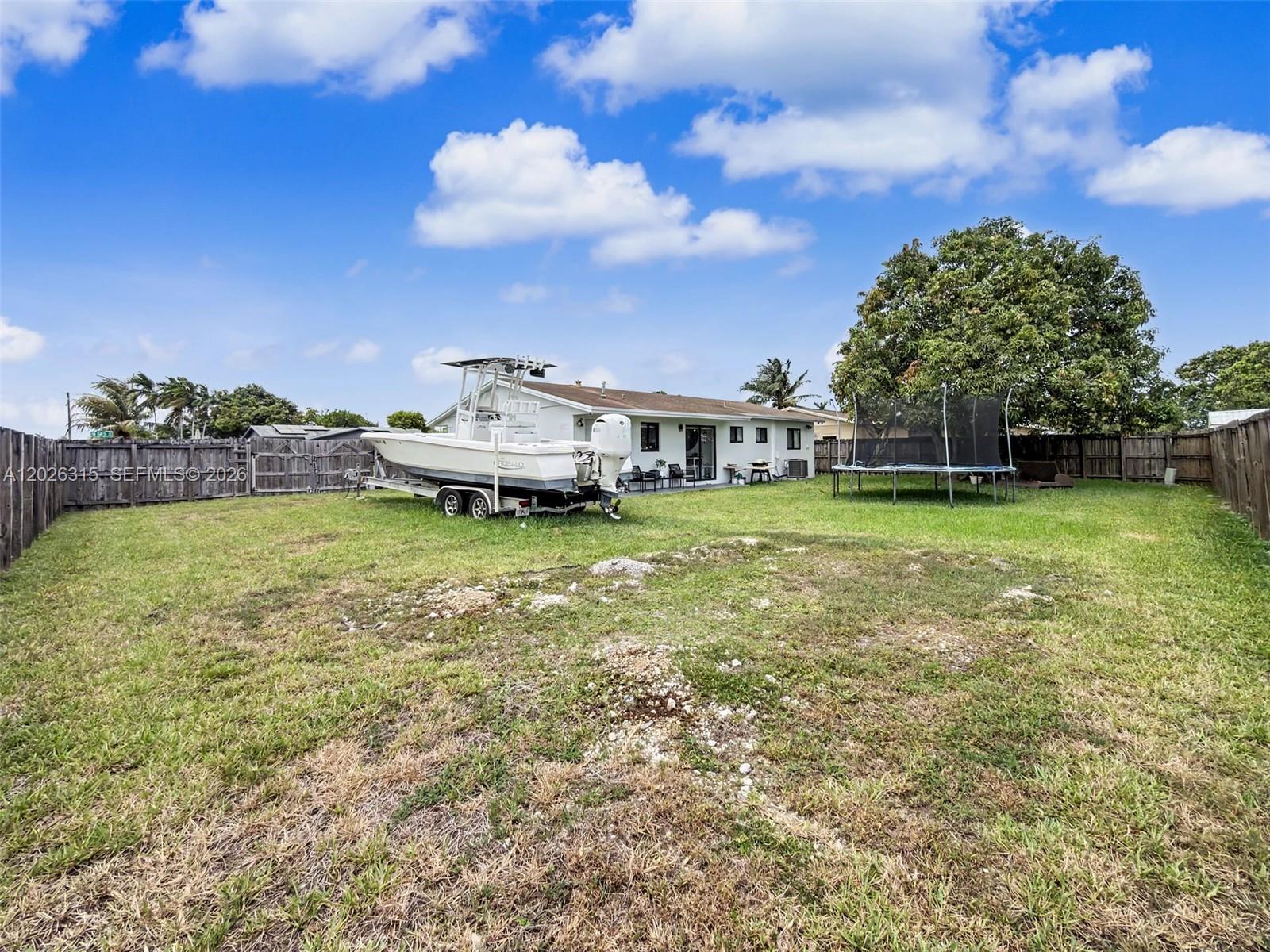 10762 Southwest 145th Street Miami, FL 33176 - Photo 24 of 28 a view of a big yard with a house in the background