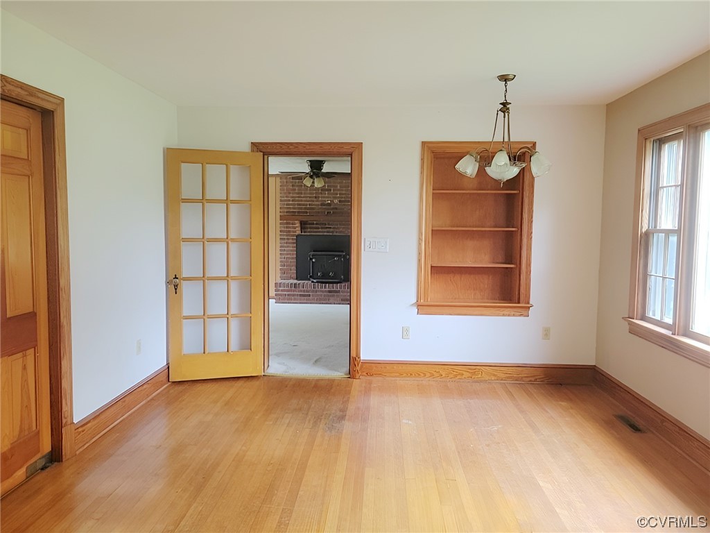 2631 White Chapel Road Lancaster, VA 22503 - Photo 2 of 19 an empty room with windows and cabinet