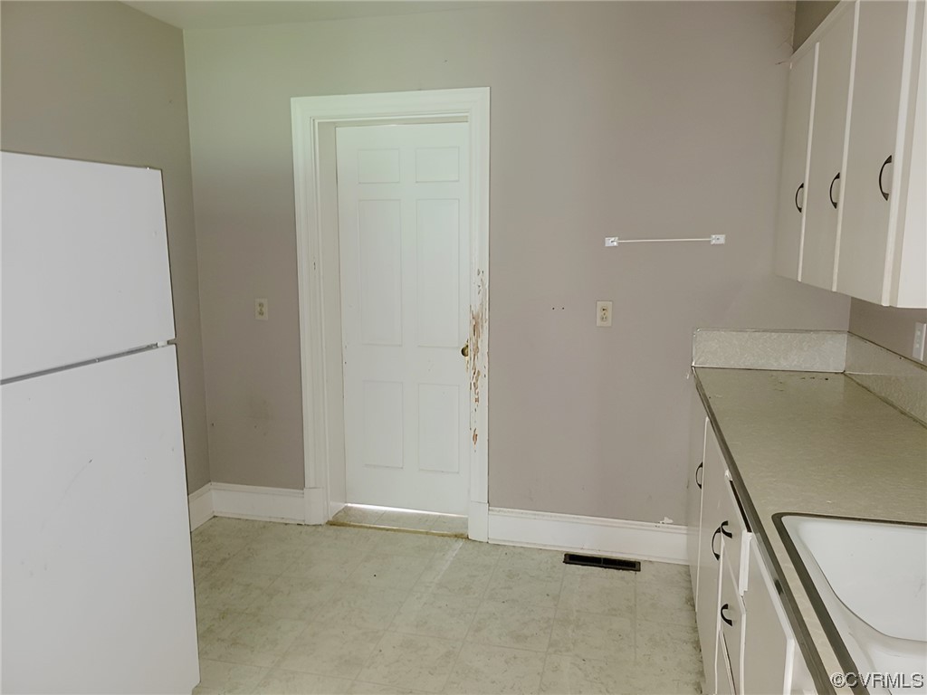 2631 White Chapel Road Lancaster, VA 22503 - Photo 7 of 19 a view of an empty room with a refrigerator
