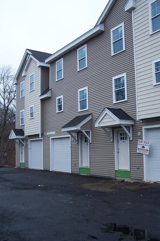 213 Main Street, Unit 2 Maynard, MA 01754 - Photo 1 of 10 a front view of residential houses with yard
