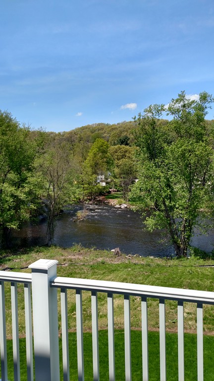 213 Main Street, Unit 2 Maynard, MA 01754 - Photo 5 of 10 a view of lake with a yard