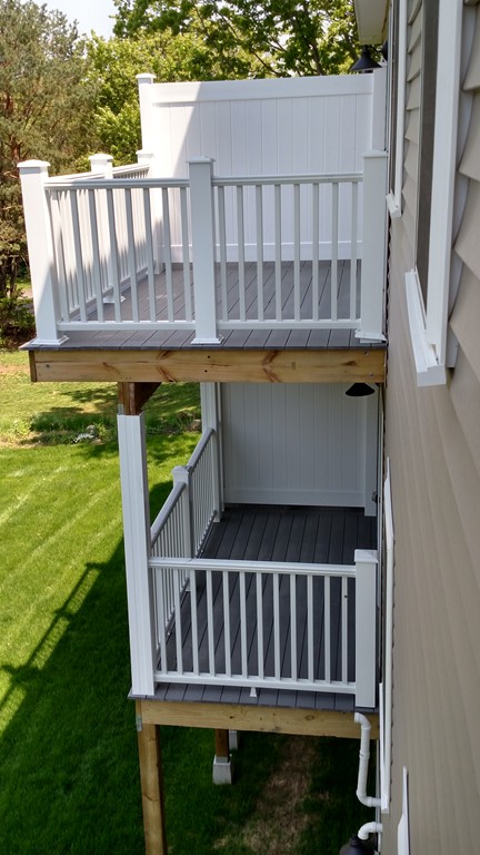 213 Main Street, Unit 2 Maynard, MA 01754 - Photo 7 of 10 a view of a balcony with wooden floor
