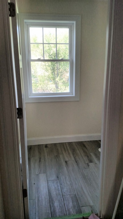 213 Main Street, Unit 2 Maynard, MA 01754 - Photo 9 of 10 a view of a small space with wooden floor and a window