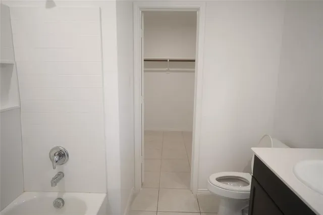 a bathroom with a sink a toilet a vanity and mirror