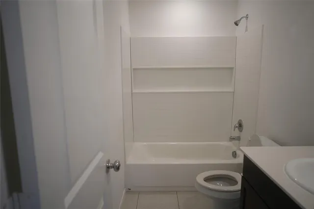a bathroom with a toilet and a tub