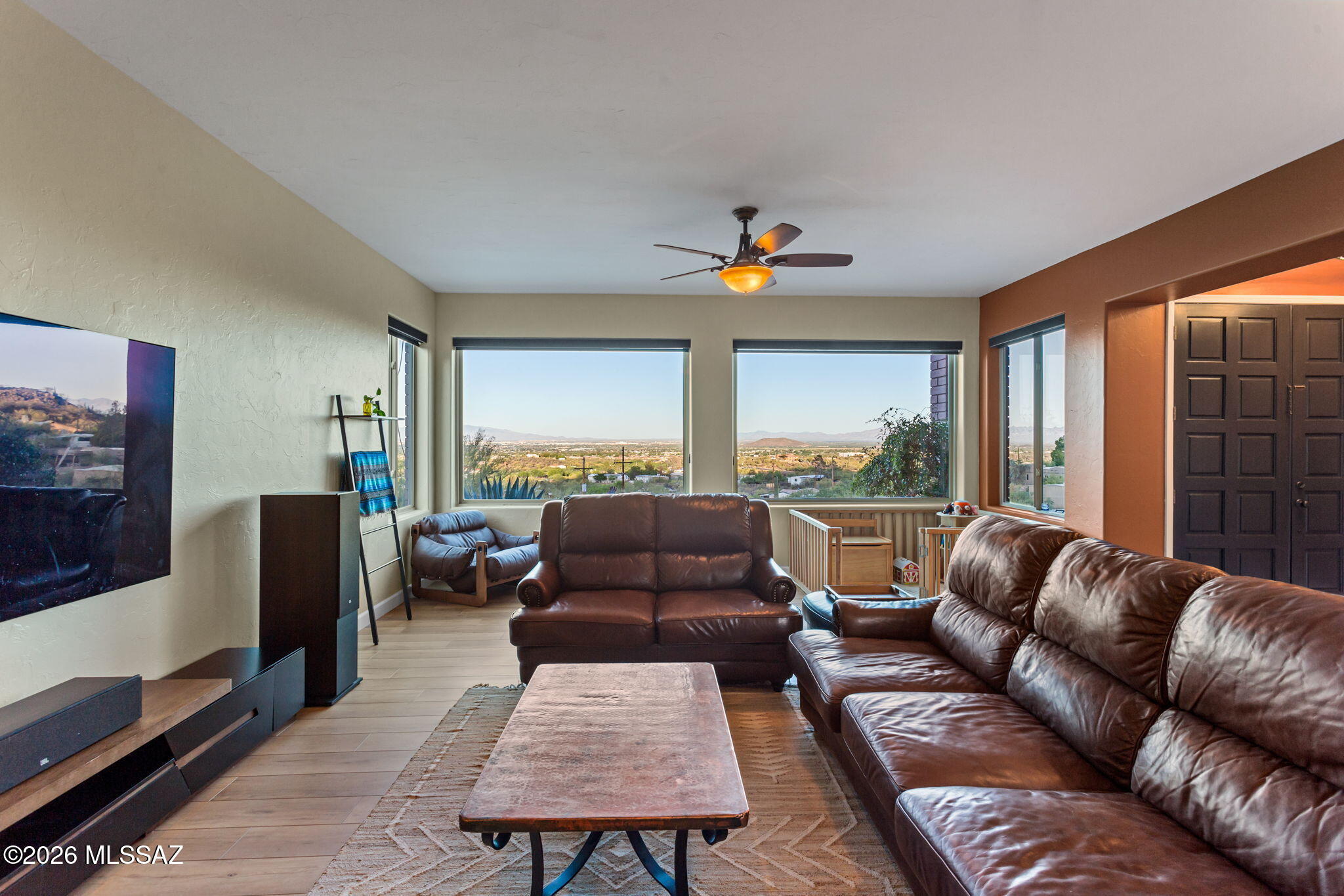 4210 West Mossman Road Tucson, AZ 85746 - Photo 13 of 51 a living room with furniture flat screen tv and a large window