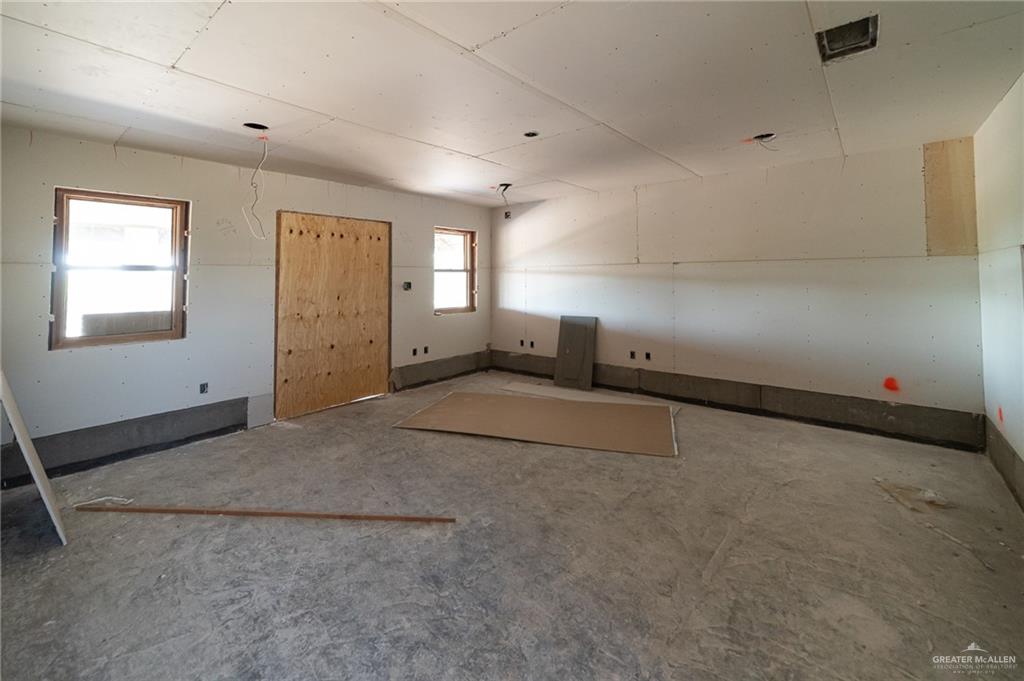 2136 East Mile 3 Road Palmhurst, TX 78573 - Photo 10 of 18 a view of an empty room with a window