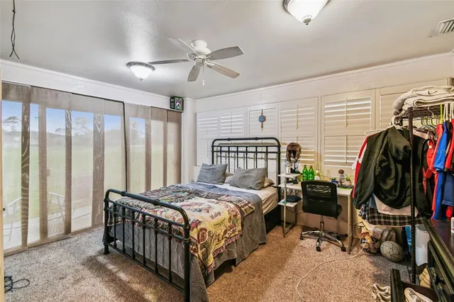 a bedroom with a bed a desk and chair