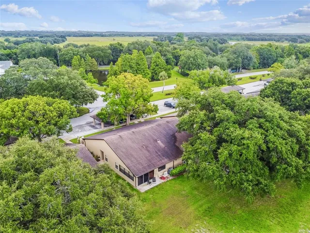 an aerial view of a house with yard and outdoor seating