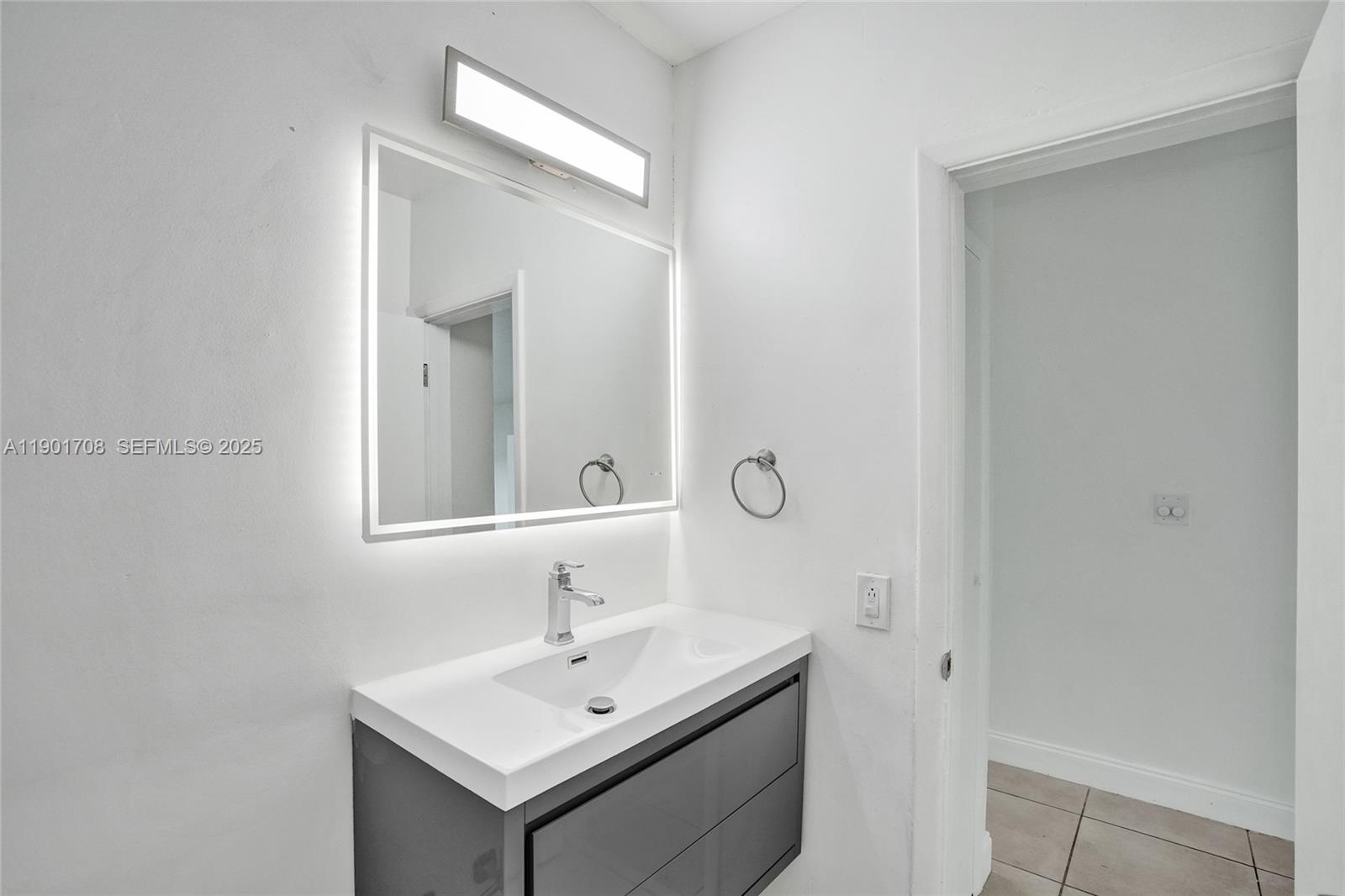 5750 Northwest 111th Street Hialeah, FL 33012 - Photo 17 of 34 a bathroom with a sink and a mirror