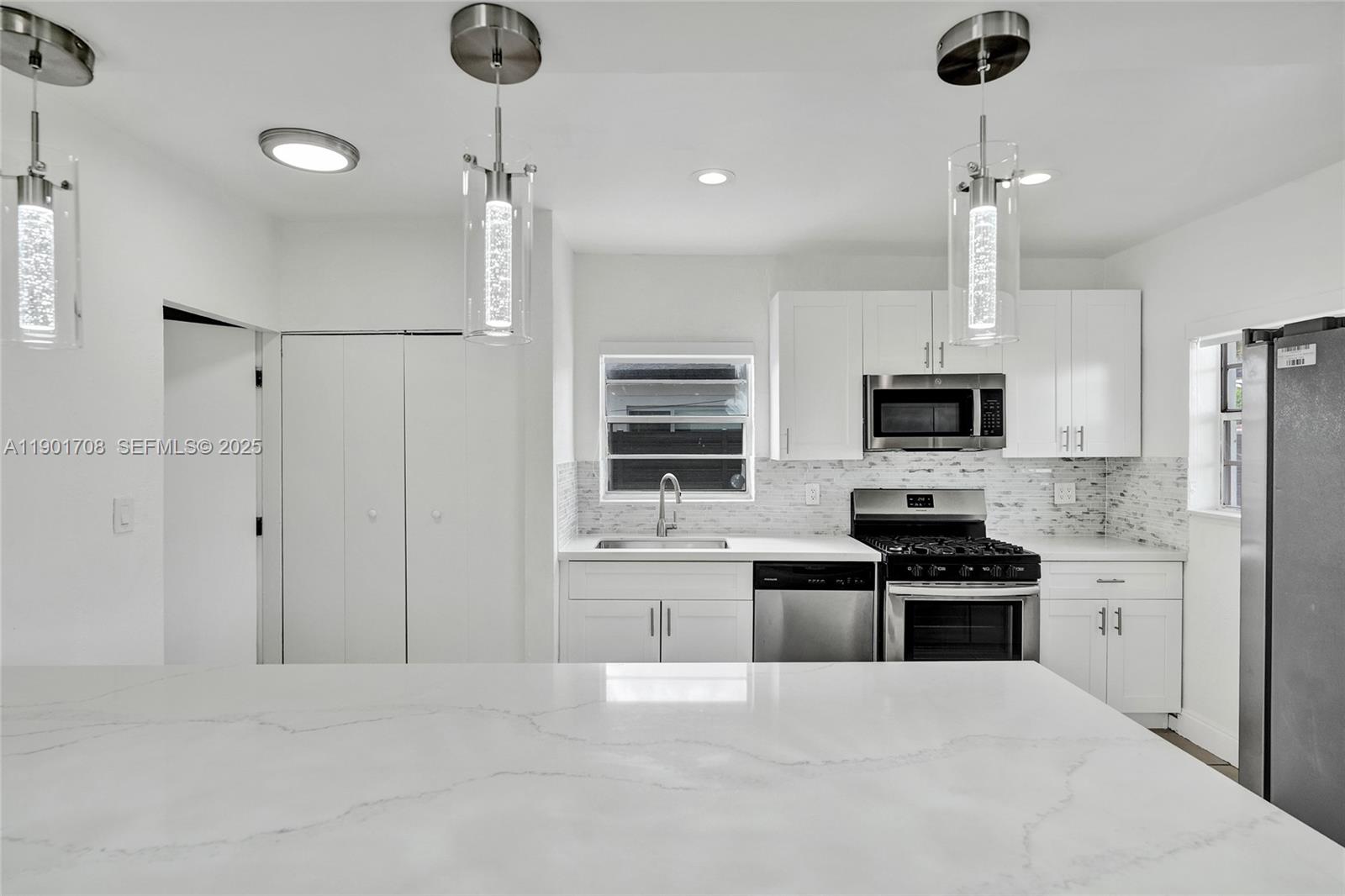 5750 Northwest 111th Street Hialeah, FL 33012 - Photo 2 of 34 a kitchen with stainless steel appliances a stove refrigerator and microwave