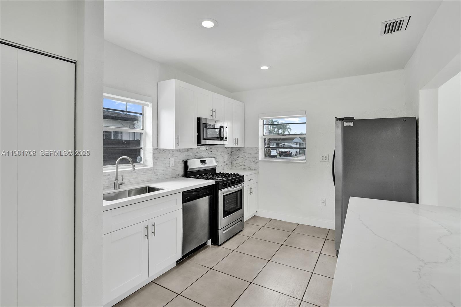 5750 Northwest 111th Street Hialeah, FL 33012 - Photo 5 of 34 a kitchen with a sink and cabinets