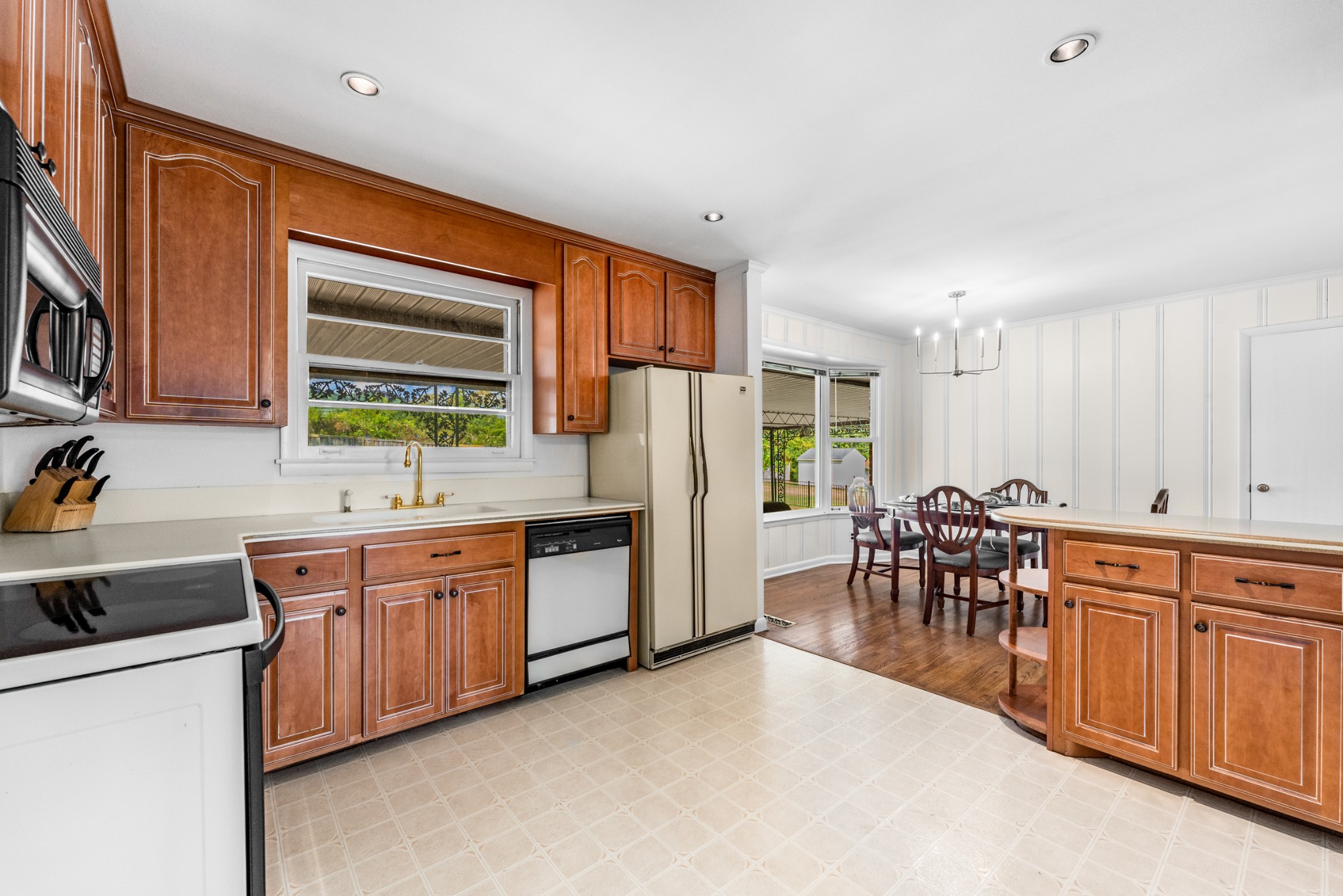 5123 Regent Drive Nashville, TN 37220 - Photo 9 of 29 a kitchen with stainless steel appliances granite countertop sink stove top oven and cabinets