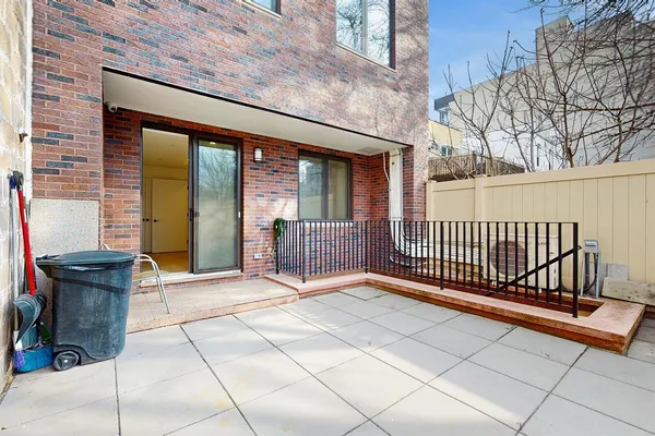 a view of a porch with a floor to ceiling window and outside view