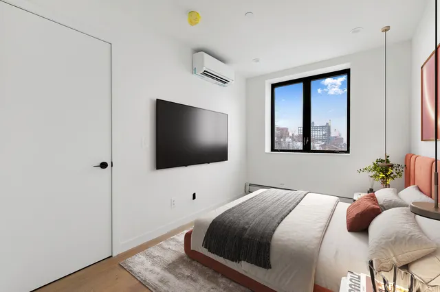 a bedroom with a bed and a flat screen tv