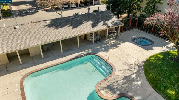 a view of a backyard with swimming pool