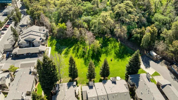 an aerial view of a house with a yard pool patio and outdoor seating